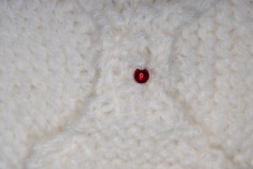 Hand knitted brooch in white with red pearl
